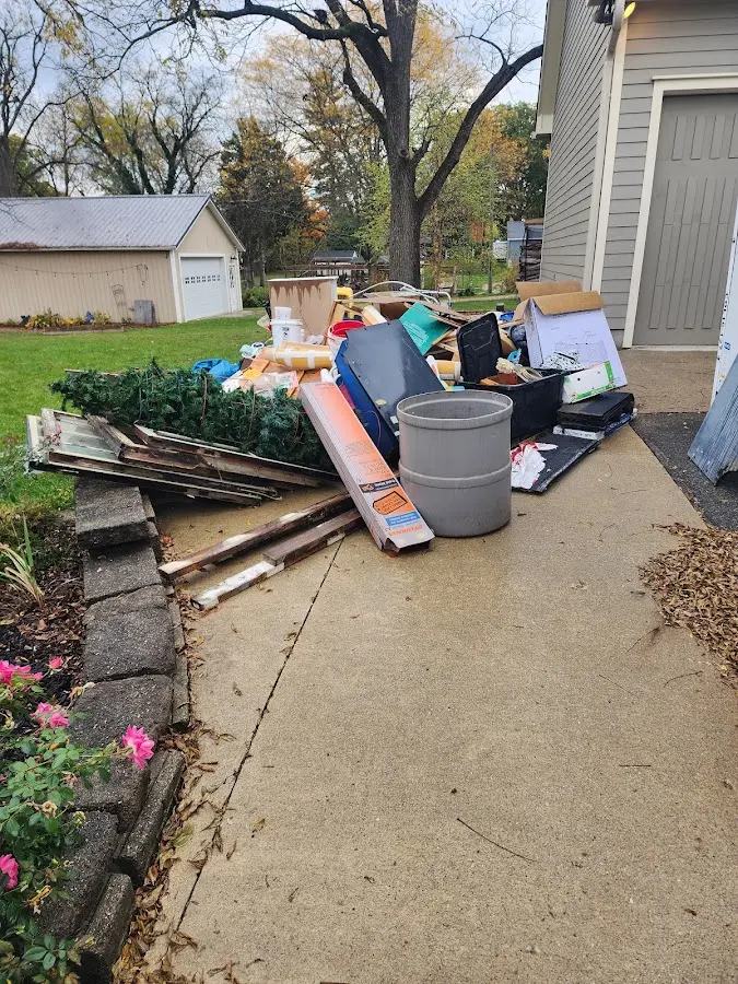 Dumpster being loaded with debris for Estate Cleanout Dumpster Rental in New Burlington